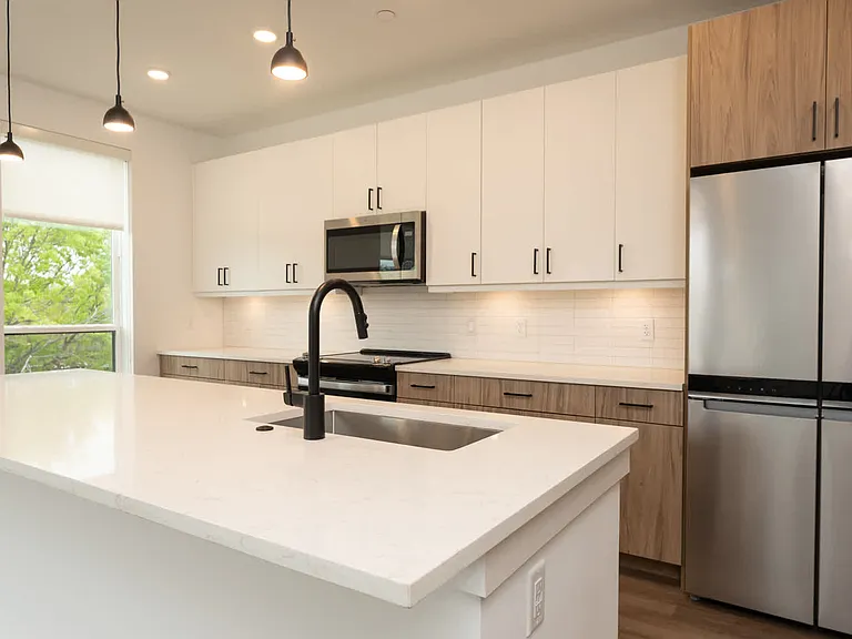 Kitchen with island and hard surface flooring