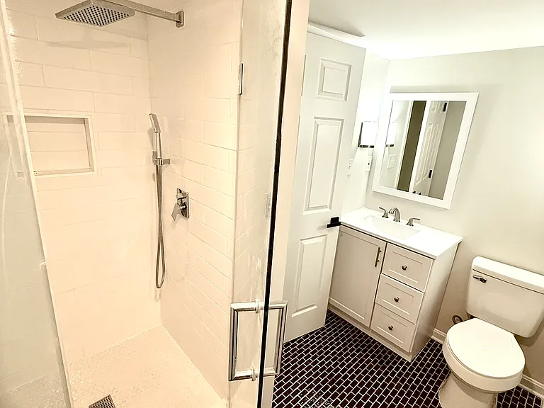 Large basement bathroom off basement bedroom with shower