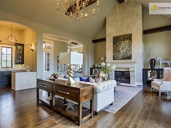 This house is perfect for entertaining. Your guests will love the stunning floor to ceiling fireplace accented by beams and the wet bar features a wine fridge, a sink, and beautiful cabinets - great for serving your guests!
