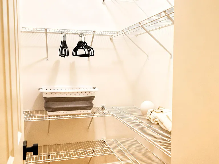 Generous walk-in closet offering abundant shelving and storage space.