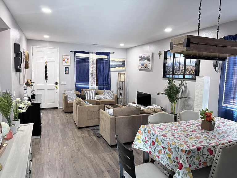 Open-concept living and dining area with recessed lighting, durable flooring, and comfortable seating for gathering.