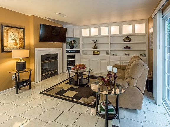 Dual fireplace backing the living room with custom