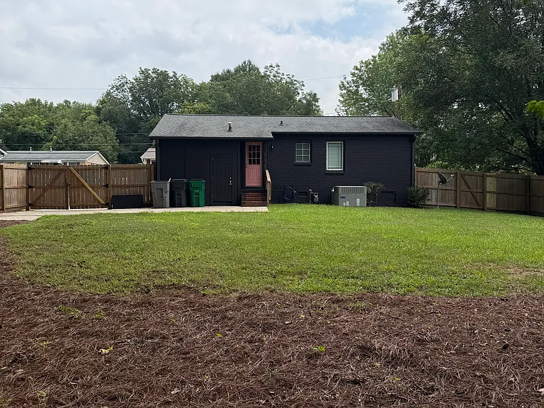 Fence gates are on either side of the house for easy access to the back - one gate is 5'+
