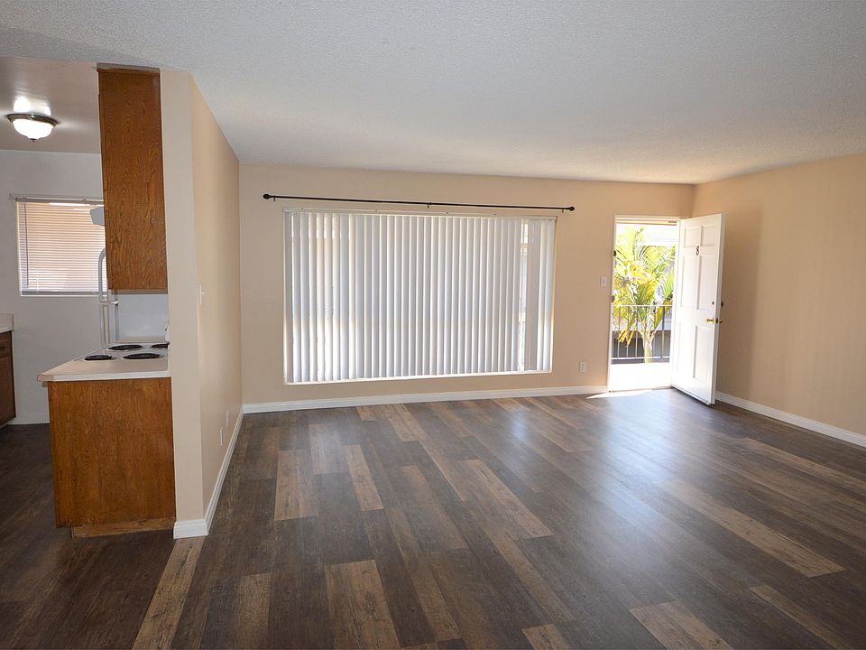 Large Living Space with Beautiful Flooring and Large Windows