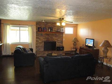 Open floorplan features a large Living Room with fireplace and "wood look" laminate flooring.