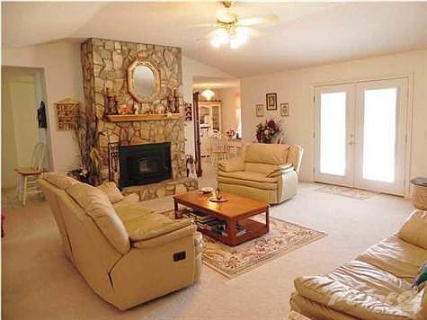 Gorgeous great room featuring Gas Fireplace and the French doors leads out to the spacious Lanai.