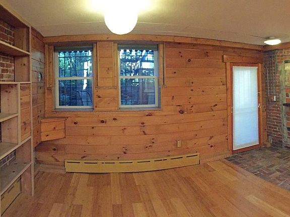 View of front of apartment, with built in bookcase.