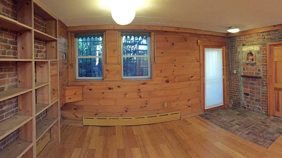 View of front of apartment, with built in bookcase.