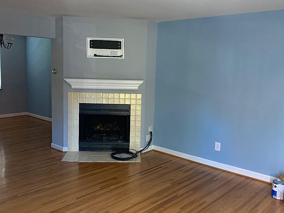 living room 14 foot by 11.5 foot with working fireplace and TV bracket above fireplace all cables are hidden in wall.
