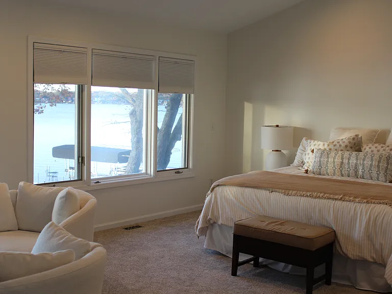 Master bedroom lined with lakeview windows