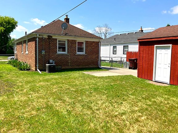 Fenced backyard. 15 car garage has electricity and remote-controlled door.