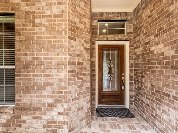 A wood and decorative, leaded glass door welcomes you inside.
