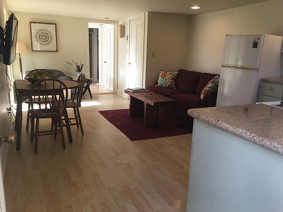 Dining, living area, looking through bedroom door toward bath