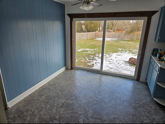 Dining room with large 8ft sliding glass door looking out at the spacious fenced in backyard with a fruit producing apple tree!