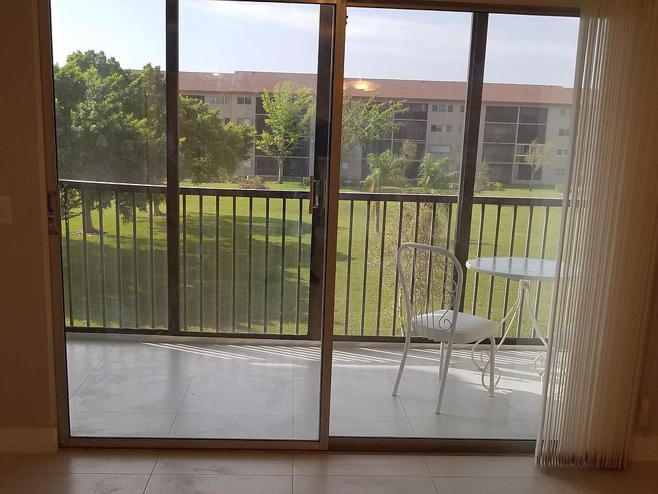 Tiled patio with screen and sliding doors.