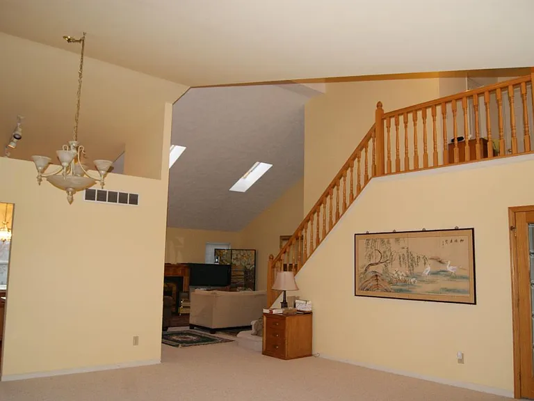 open concept living space with cathedral ceiling and sun lig