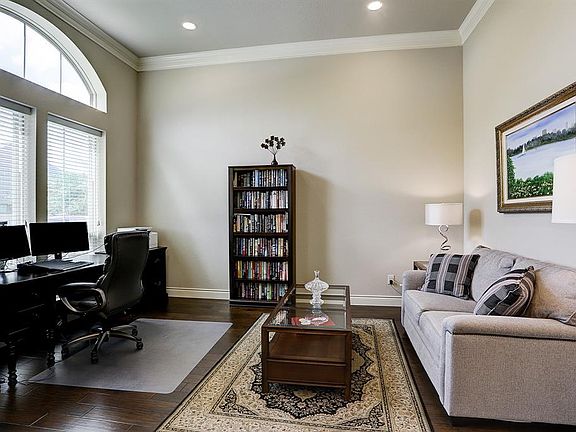 The Formal Living/Study features hard wood floors, recessed lighting, and tall ceiling with crown molding.