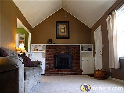Living Room w/ fireplace & vaulted ceiling