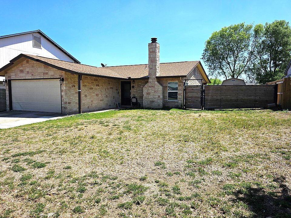Front of home with gate to park a trailer