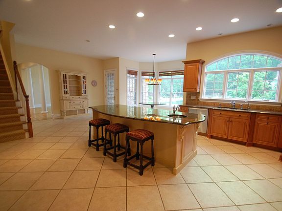 Kitchen: back staircase, recessed lights, French door to patio