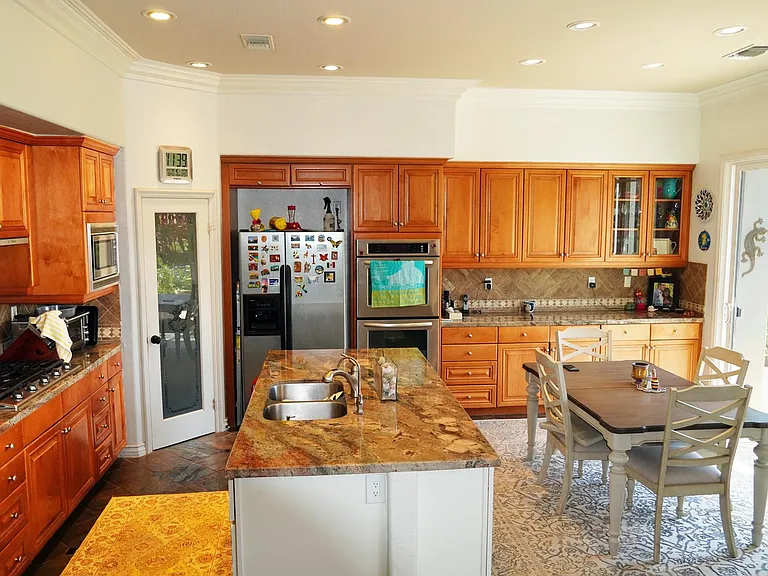 Newly remodeled kitchen with granite counters and slate floors. Cabinets contain tons of plates, cookware, utensils, glasses of every type.