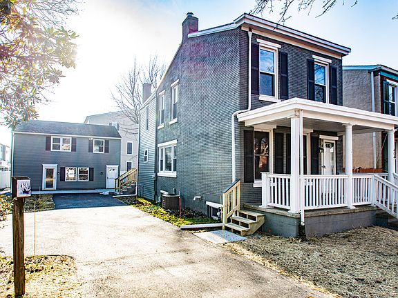 Exterior drive showing carriage house positioned in rear of lot.