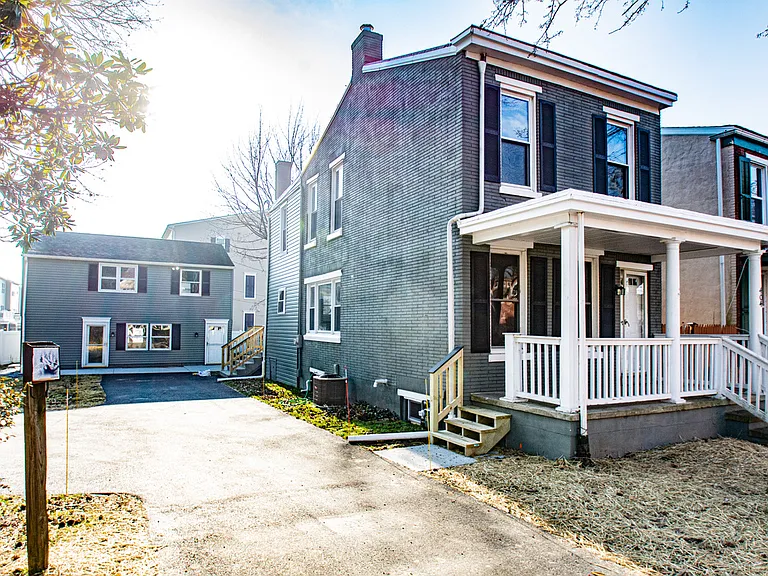 Exterior drive showing carriage house positioned in rear of lot.
