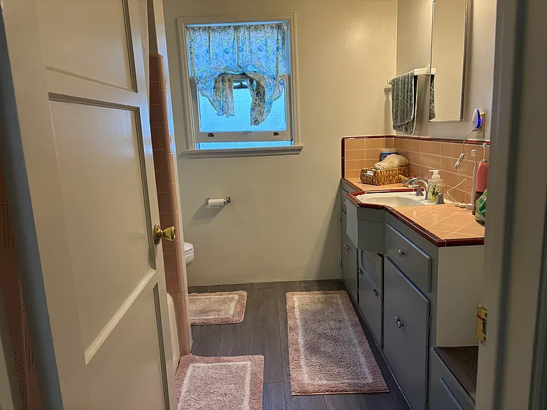 Oversized bathroom with abundant storage space, built-in shelves, and a spacious, functional layout.