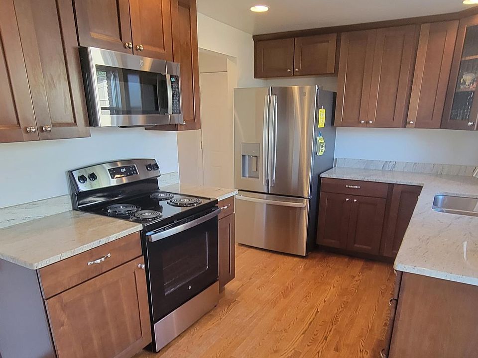 Kitchen with Newer Appliances. Refrigerator, Stove, Microwave and Dishwasher.