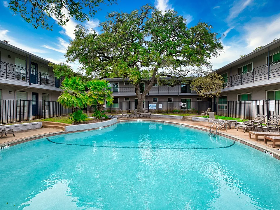 Large fenced pool with patio furniture