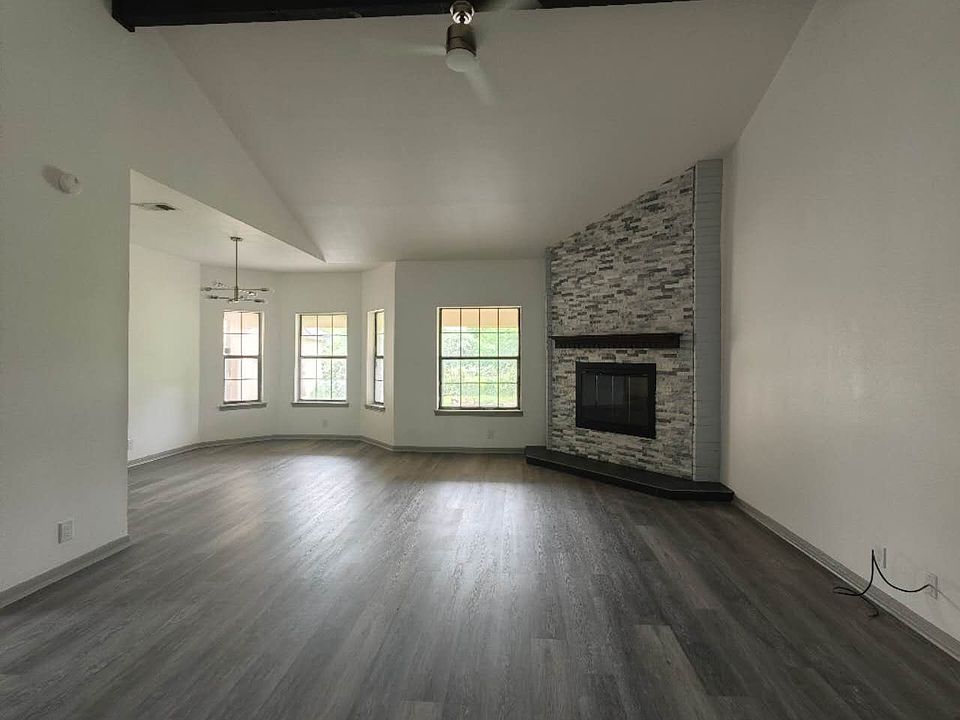 high ceiling family room with wood fireplace