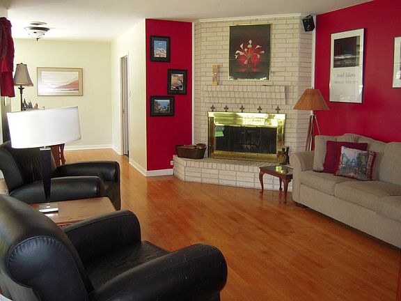 Living Room with original hardwoods and wood-burning fireplace