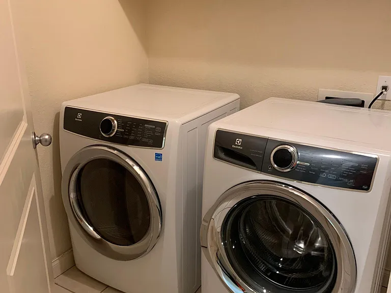 Separate laundry room with washer and dryer provided by owner.