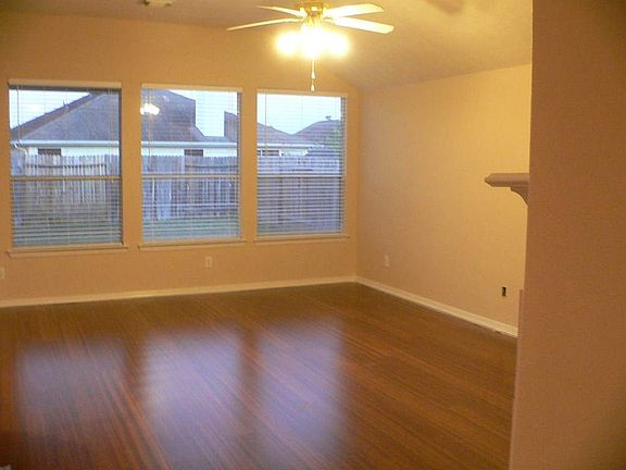 Another view of family room showing lots of windows, two-inch blinds and a beautiful Mahogany wood l