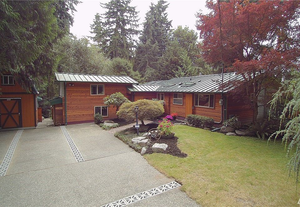 Welcome to Your Cabin in the City - Private Oasis Nestled on Over a Half Acre! 2 Bedrooms, Loft/3rd Bedroom and 2 Baths. Remodeled Lower Bath Featuring Tile Shower, Heated Floor and Bidet. Remodeled Kitchen Features Quartz Counters, Stainless Steel Appliances (including a Double Oven), Breakfast Bar and Skylight. Opens to Great room Highlighted by Hardwoods, Gas Fireplace with Brick Surround and Picturesque Windows Looking Out to Your Private Retreat. Formal Dining off Kitchen with Skylights. Fu