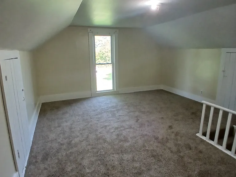 upstairs bedroom with access to attic storage