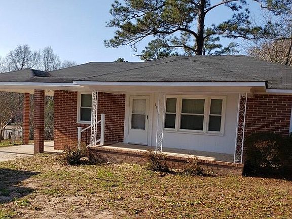 Lovely four sided brick home with a porch.