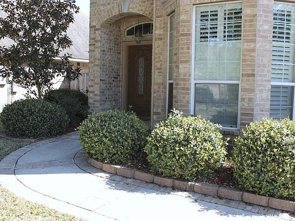Lovely front path with arched Entry welcomes you in.