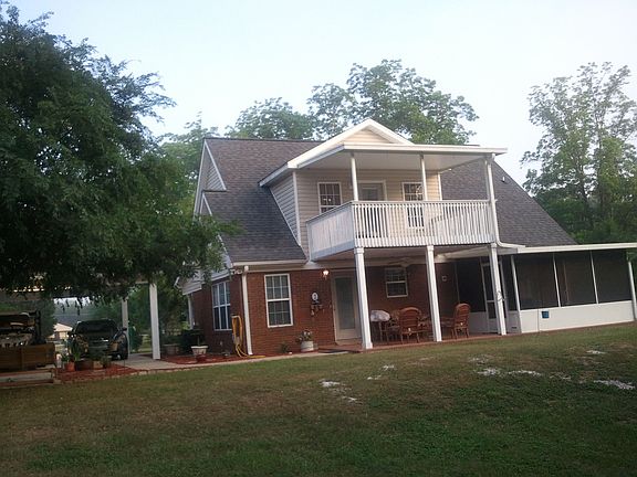 Back of House showing covered porch and upstairs deck