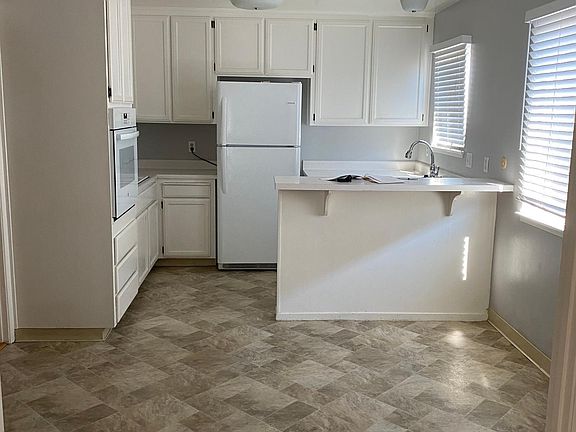 Bright white open kitchen with breakfast bar