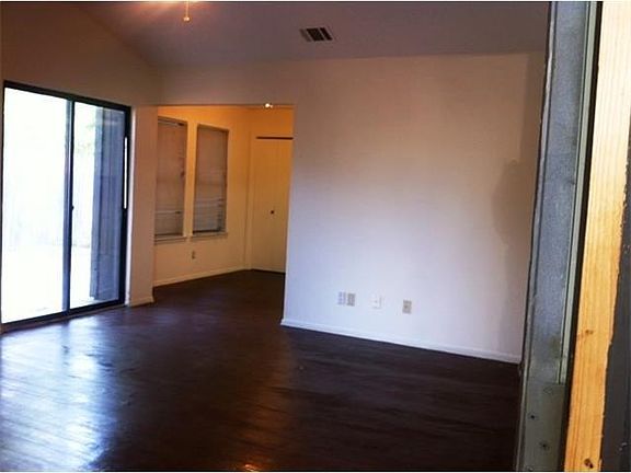 Living area with wooden plank vinyl floors and sliding glass