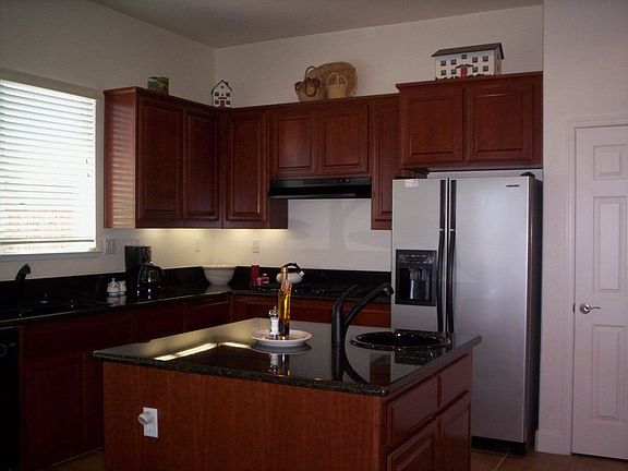 Kitchen with Granite Countertops, Tile Floor, Cherry Cabinets