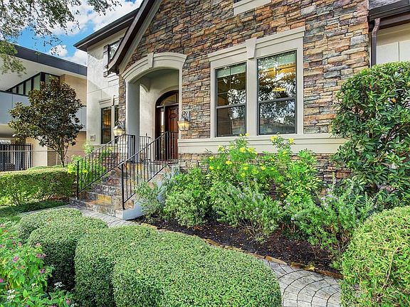 Another View:Beautiful precise landscaping complete with irrigation surround the stamped concrete sidewalk leading to the slated