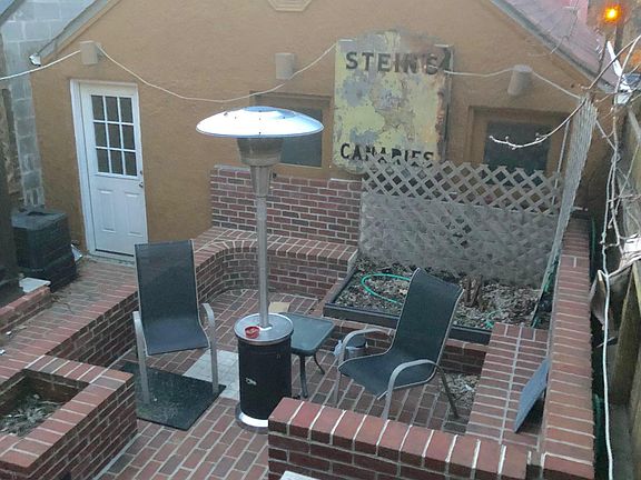View of the backyard from the deck off the kitchen and sun room. There are about 40 feet of raised and covered flower bed. Each section of the bed is separately monitored for water. Compost is back left corner.
