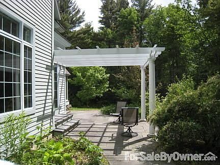 Pergola covered stone patio