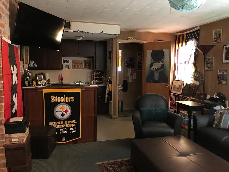 partial view of den with bar and half bathroom