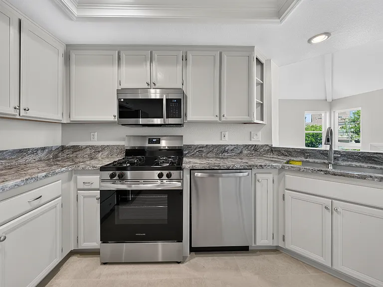 KITCHEN HAS BEEN REMODELED AND PAINTED. GRANITE COUNTER, NEW STOVE AND DISHWASHER