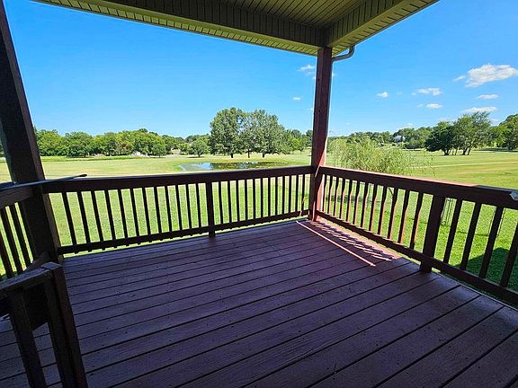 Deck overlooking golf course with seasonal lake views