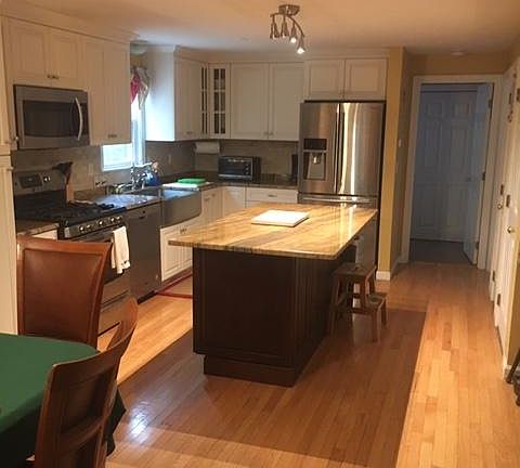 Updated kitchen with island, granite countertops
