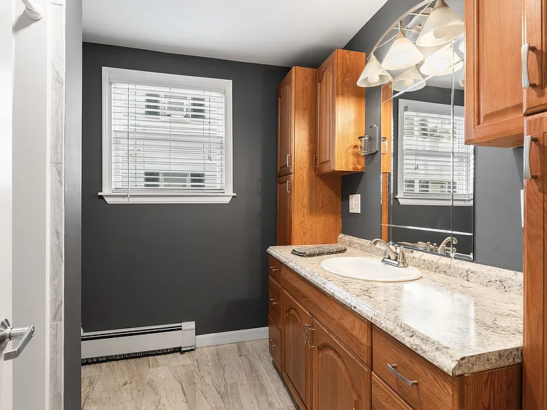 Full Bathroom, Oak Cabinets, Granite Countertop, Tile Flooring, Modern Lighting, Medicine Cabinet, Vanity.